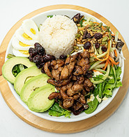 a banhmi bowl filled with fresh vegetables and savory meats.